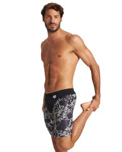 Front view of man holding his left leg with left hand wearing Arena Earth Texture Jammer - Black/ Black Multi